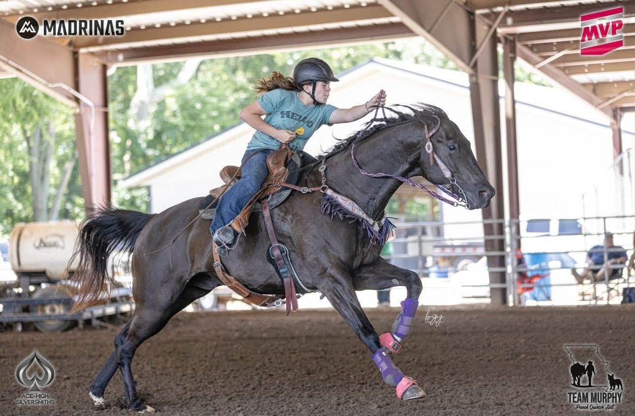 Silvy Batchelder running her black horse
